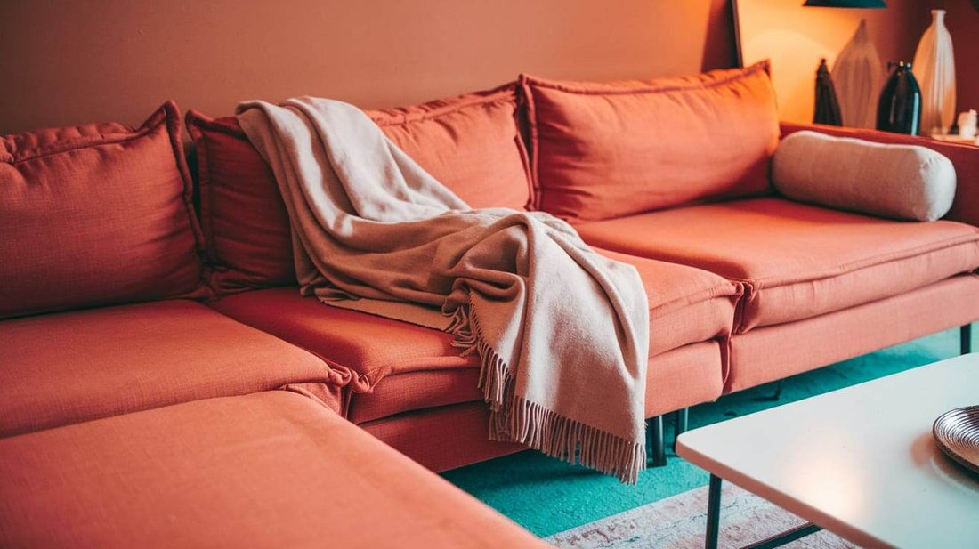 a living room with a couch in a vibrant orange hue