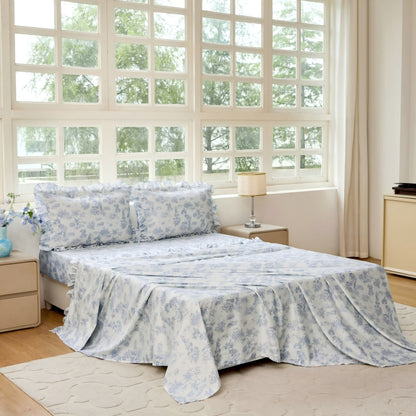 Bed with green floral patterned bedding in a bedroom setting