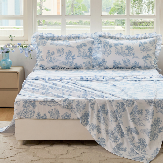 Bed with red floral patterned bedding in a bedroom setting.