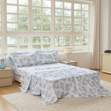 Bed with green floral patterned bedding in a bedroom setting