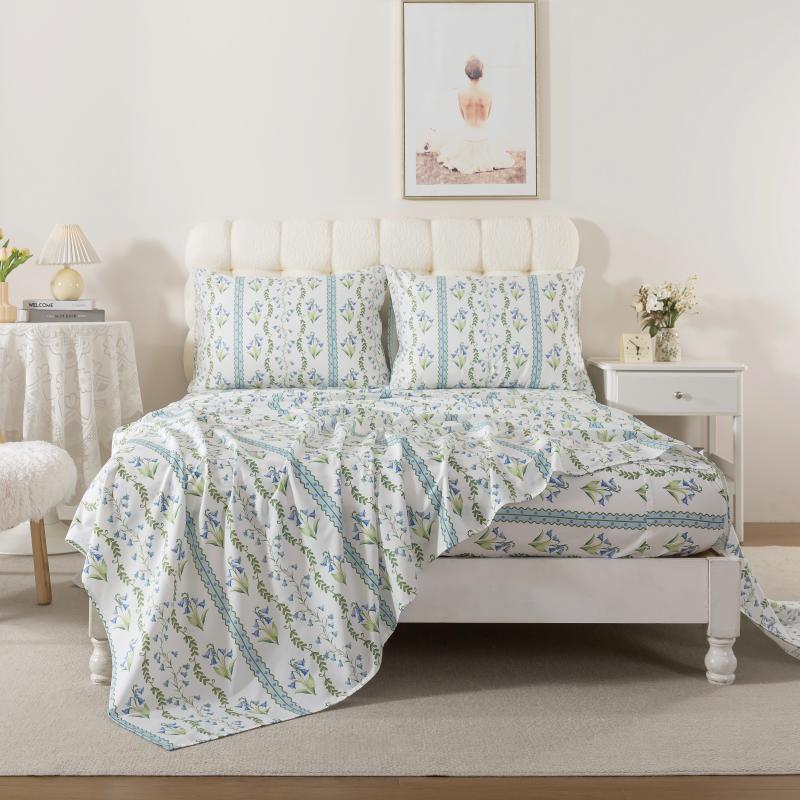 Bed with red floral patterned bedding in a bedroom setting.