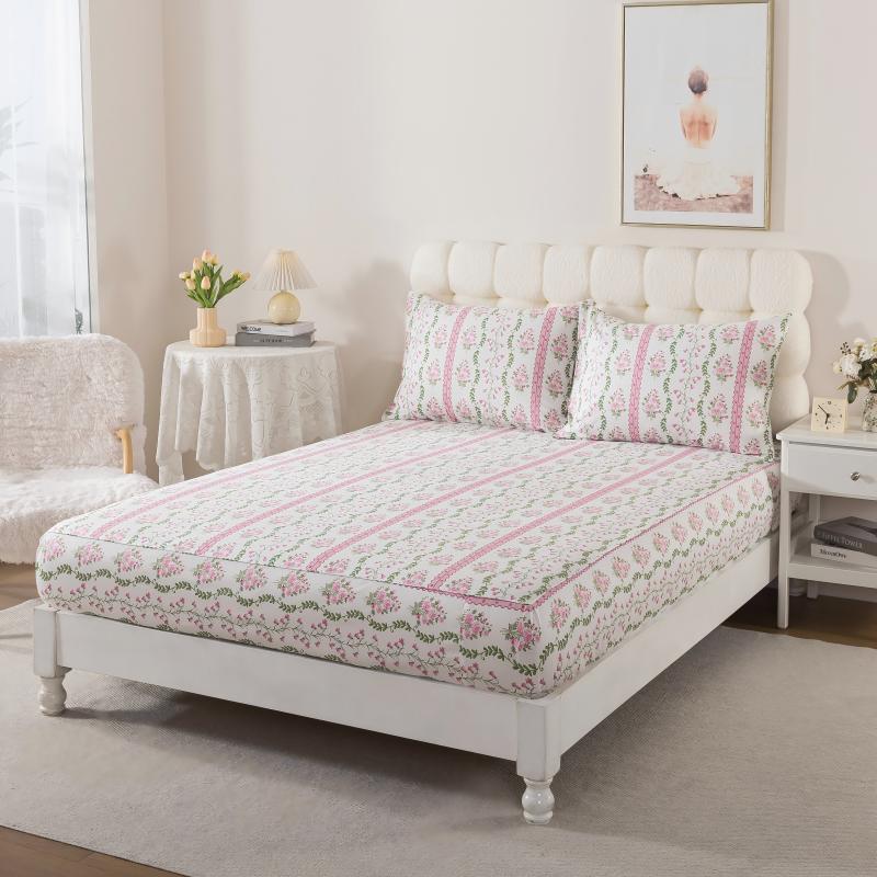 Bed with green floral patterned bedding in a bedroom setting