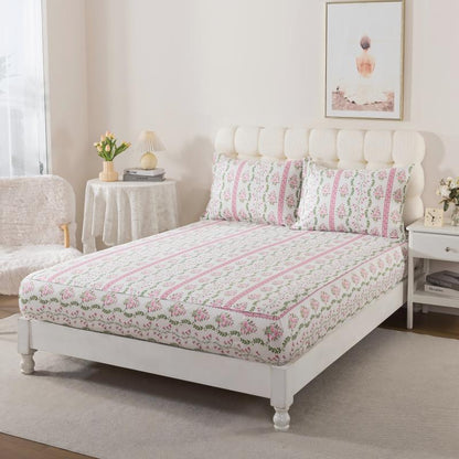 Bed with green floral patterned bedding in a bedroom setting