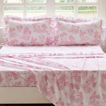 Bed with red floral patterned bedding in a bedroom setting.