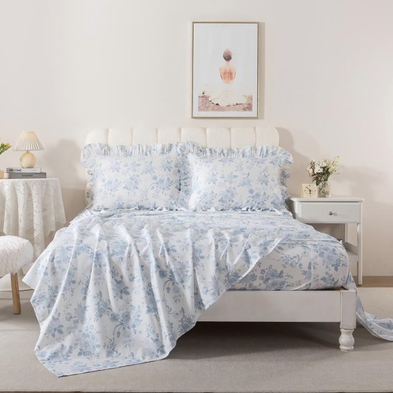 Bed with red floral patterned bedding in a bedroom setting.