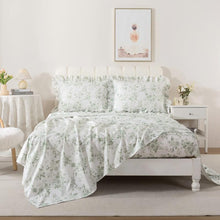 Bed with red floral patterned bedding in a bedroom setting.