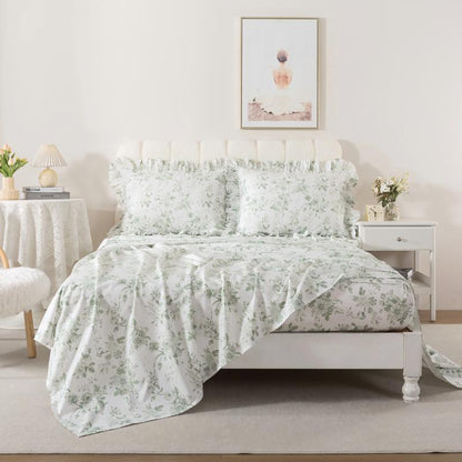 Bed with red floral patterned bedding in a bedroom setting.