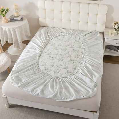 Floral-patterned mattress cover on a bed in a bedroom setting