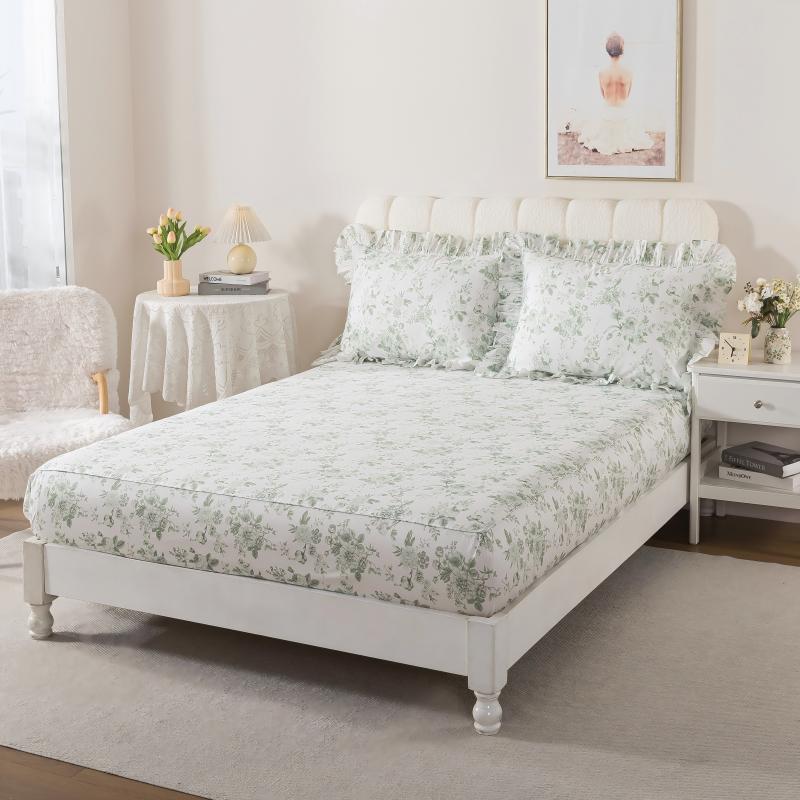Bed with green floral patterned bedding in a bedroom setting