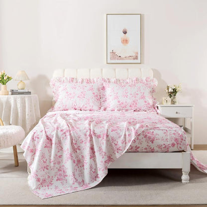 Bed with red floral patterned bedding in a bedroom setting.