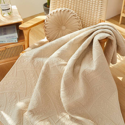 This throw blanket has a beige leaf pattern