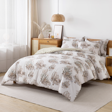 Bedroom with floral-patterned bedding and a plant