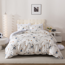 Neatly made bed with white comforter in a bright bedroom setting
