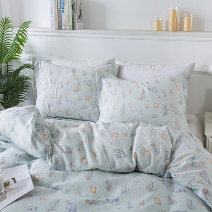 Floral patterned bedding set on a bed with a white headboard and candles in the background.
