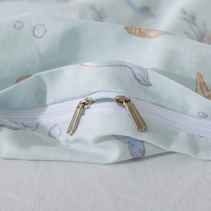 Close-up of a fabric bag with a zipper and shell pattern on a light blue background