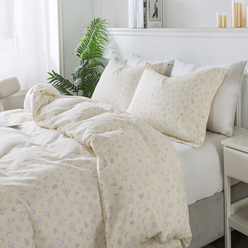 Bed with floral-patterned bedding in a bright bedroom setting