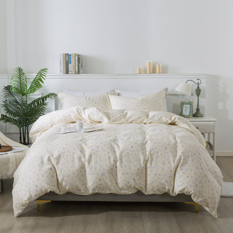 Neatly made bed with white comforter in a bright bedroom setting