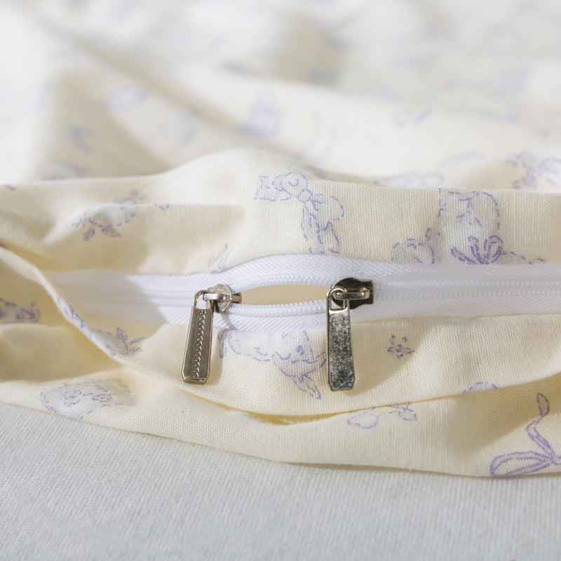Close-up of a zipper on a floral-patterned fabric with a soft focus background.